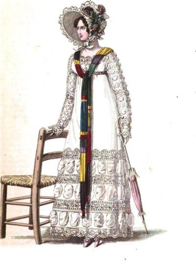 From the October 1818 edition, La Belle Assemblee, we have the Parisian promenade dress made of cambric muslin and trimmed in muslin medallion puffs which are separated by rich embroidery, topped by a bonnet of white crape trimmed with blond and purple poppies on the side